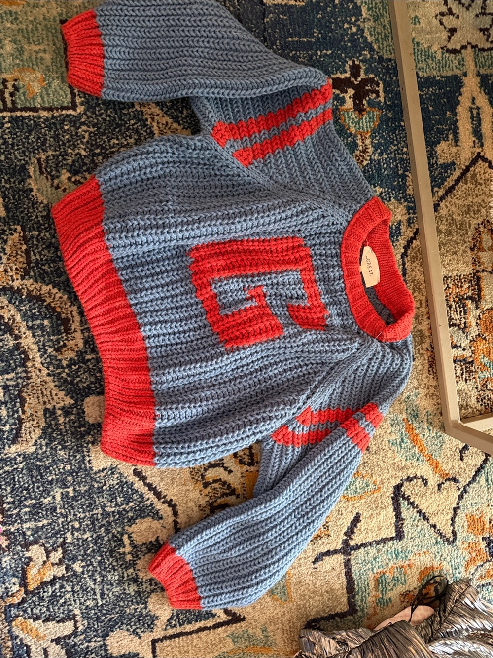 THE GREAT. Light Blue Knit Sweater with Red Trim and G Emblem